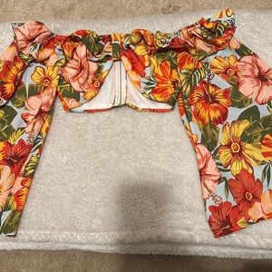 A never worn colorful zip up top. Flared out sleeves,close in size to a bralette